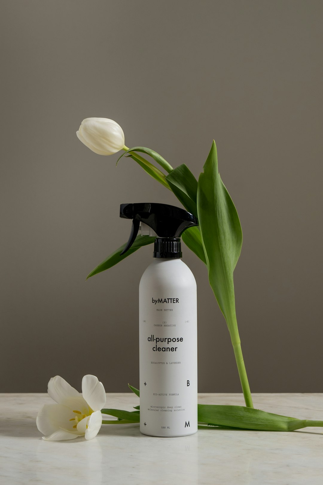 a-bottle-of-deodorant-next-to-a-flower-bm3nfgcecse